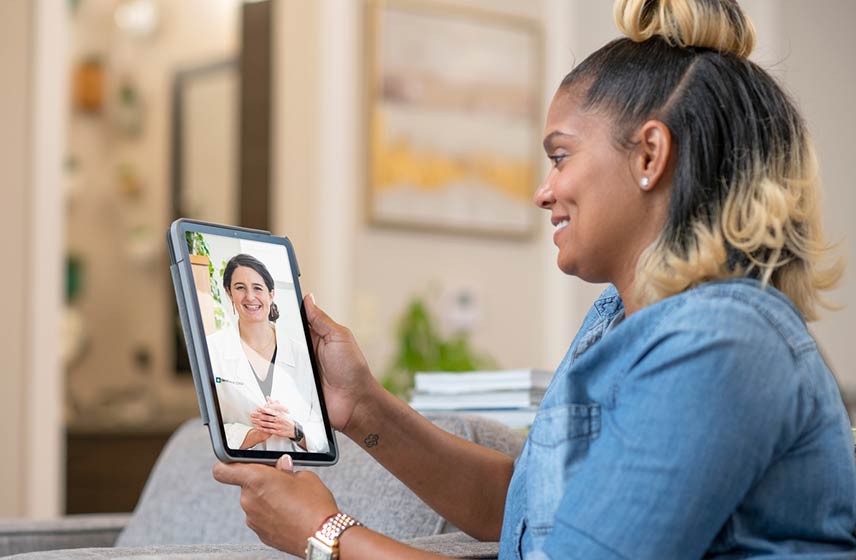 Woman talking to Cleveland Clinic expert on tablet.